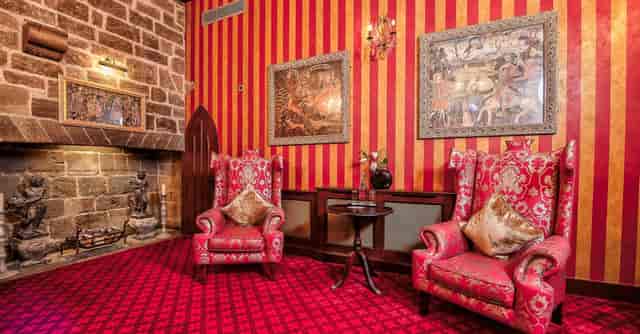 Stuart Suite at Langley Castle Hotel: elegant meeting space with plush armchairs.