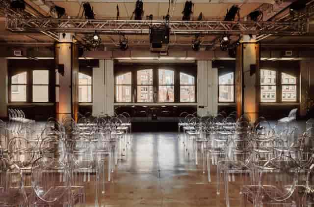 District Lounge event space with acrylic chairs, ideal for conferences and performances.