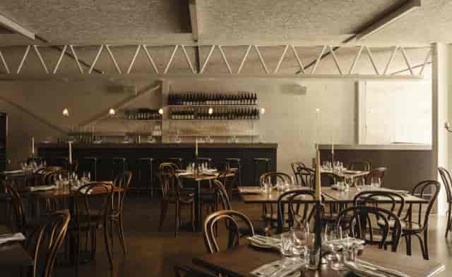 Private dining room with industrial-chic design for corporate receptions and business dinners.