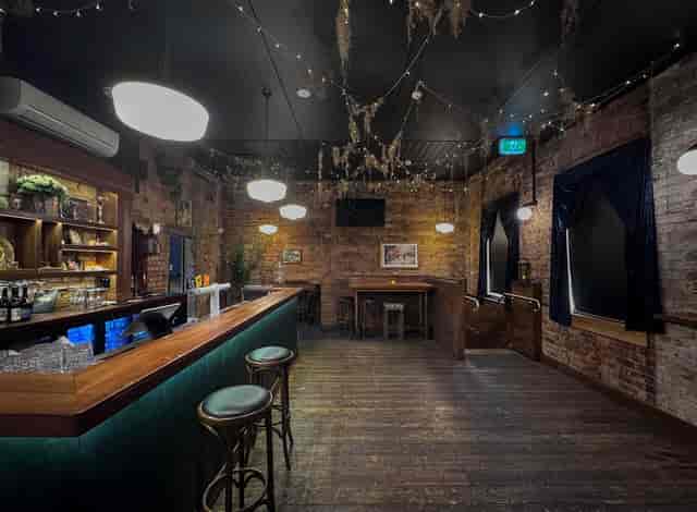 Cozy Private Function Room at Polly Bar with exposed brick, perfect for cocktail events.