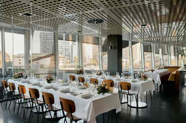 Elegant dining area with city view in Transit Rooftop Bar for upscale events.