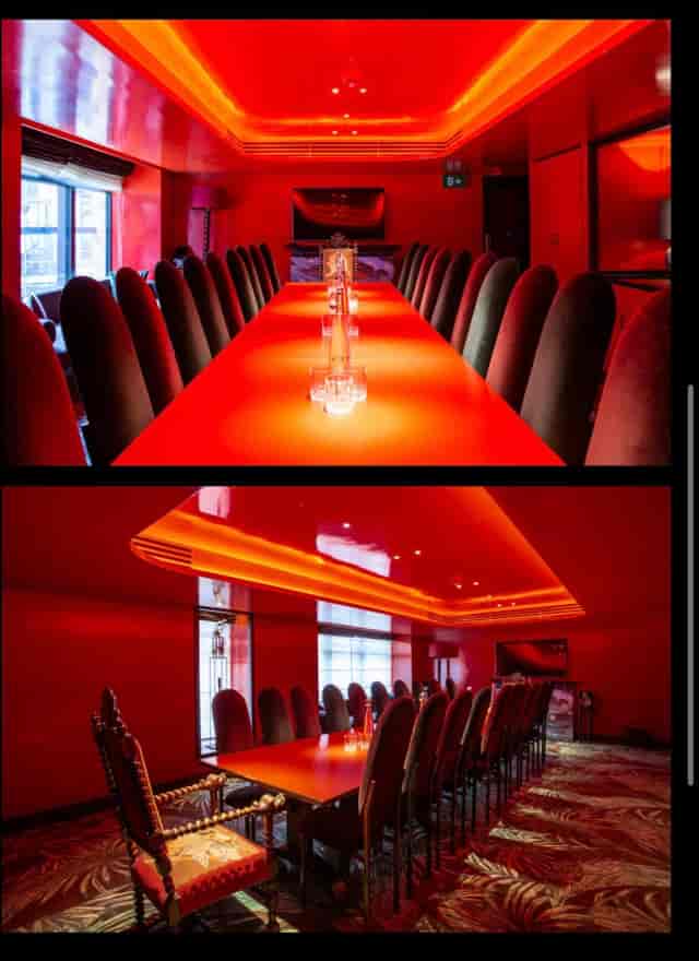 Red monochromatic private dining room at The Mandrake, ideal for exclusive corporate events.