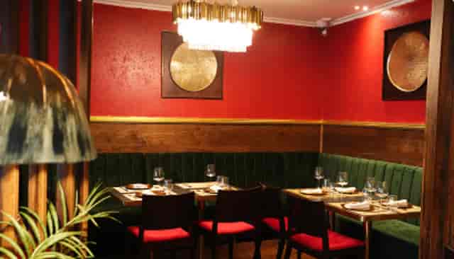 Intimate dining venue with rich red walls ideal for networking dinners and private events.