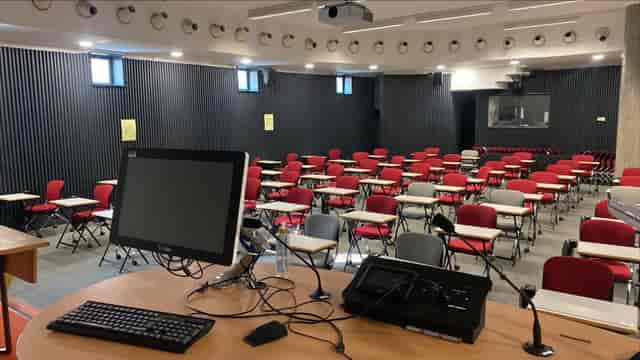 London Uni lecture hall, tiered seating, academic conference, educational seminar