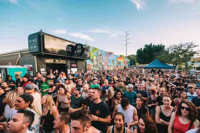 Outdoor festival activation at Badlands Bar with vibrant mural backdrop for event venues.