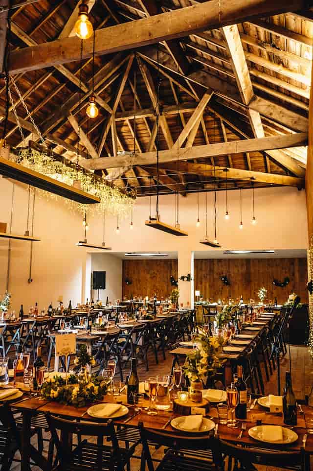 Rustic-chic event venue with Edison lighting for corporate dinners and weddings.