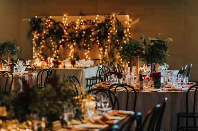 University Club WA gala banquet hall with ambient string lighting and greenery for wedding events.