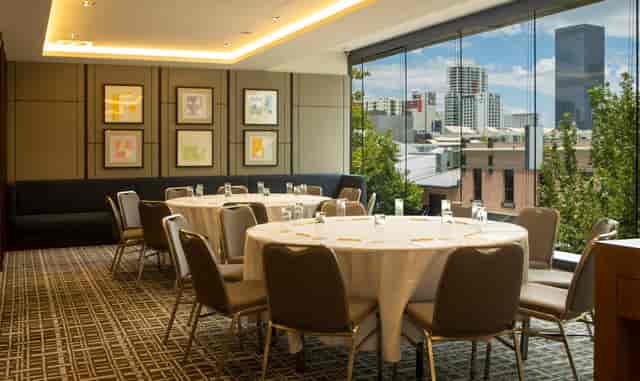 Postal Hall breakout room with banquet seating and city views for executive meetings and events.