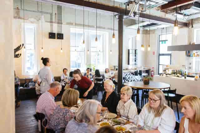 Industrial-chic networking luncheon with communal seating for corporate events.