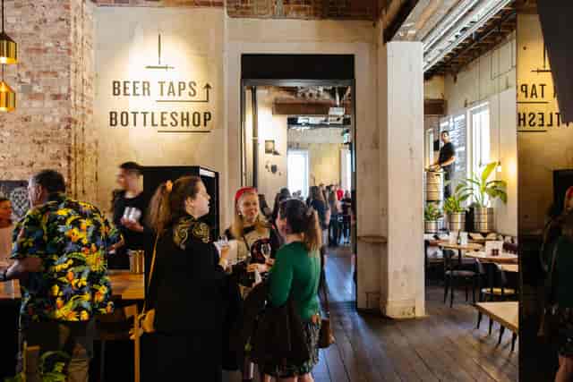 Industrial-chic Beer Corner in State Buildings, ideal for conference networking mixers.