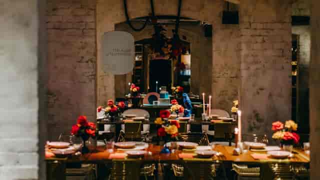 Long Chim industrial-chic event space with candlelit table for corporate dinners and social events.