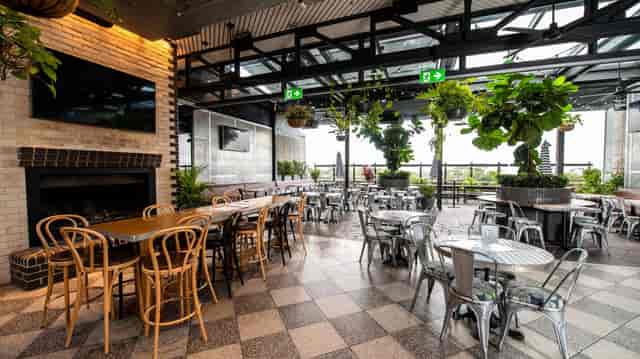 Private dining room at Highfield Caringbah with industrial fireplace for corporate events.