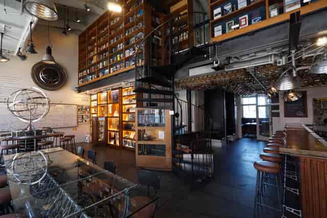 Industrial-chic Main Space venue with bar seating for networking events and product launches.