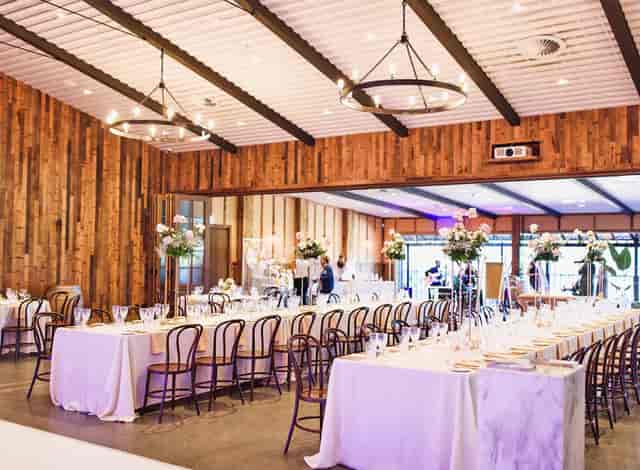 Sandalera Room banquet setup with wood paneling and chandeliers for corporate events or weddings.