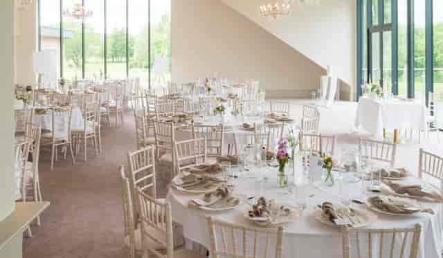 Garden Suite banquet hall with floor-to-ceiling windows for corporate galas and wedding receptions.