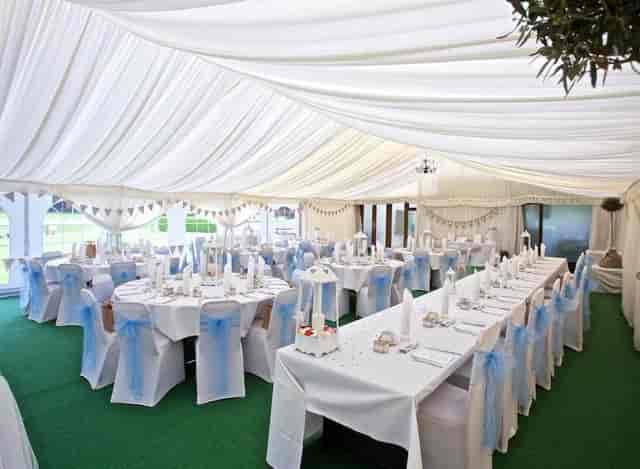 Garden Suite marquee with blue sashes for wedding and corporate gala events.