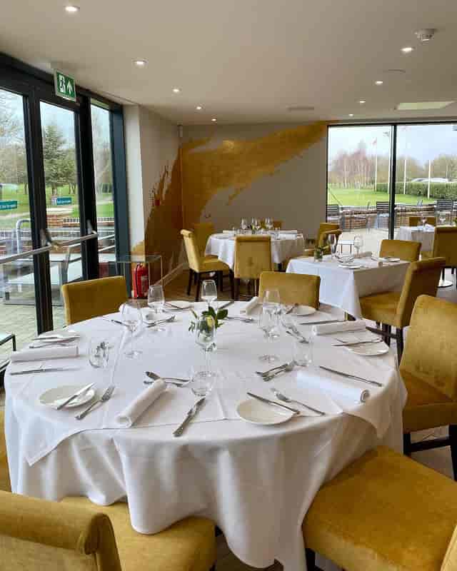 Garden Suite banquet room with mustard chairs, ideal for corporate events and social luncheons.