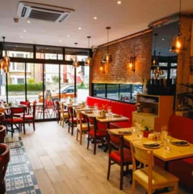 Cozy Luna Llena Restaurant with red leather banquettes, perfect for intimate gatherings.