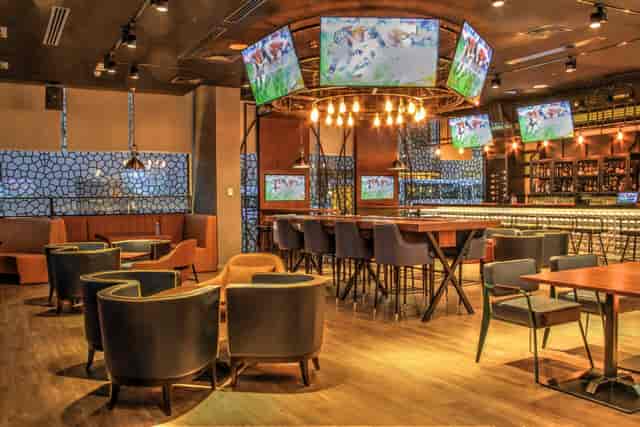 Modern dining room in sports bar, versatile space for events and presentations.