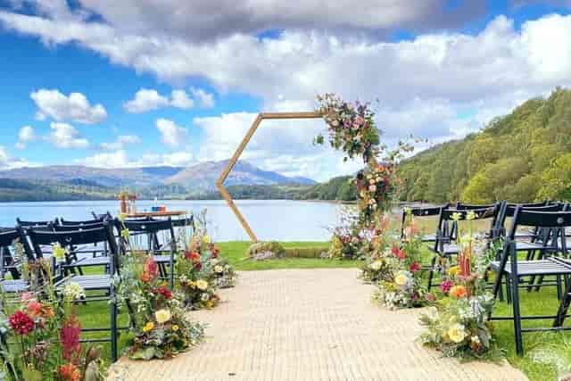 Outdoor wedding ceremony at Venachar Lochside with geometric arch. Luxury minimalist event venue.
