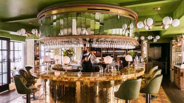 Chic circular bar at Griglia, Pink Mamma, perfect for networking and gatherings.