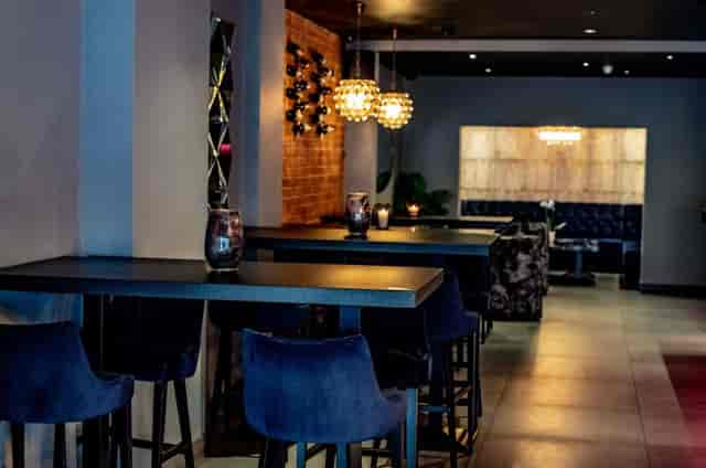 Stylish Fire&Ice event space with sleek high-top tables for modern gatherings.