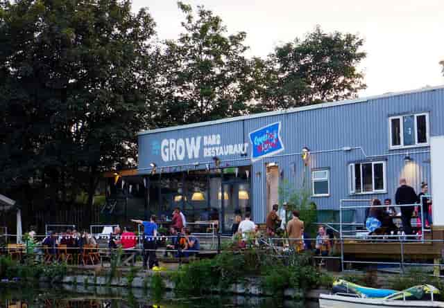 Industrial waterfront event venue with outdoor seating, ideal for team building and networking.