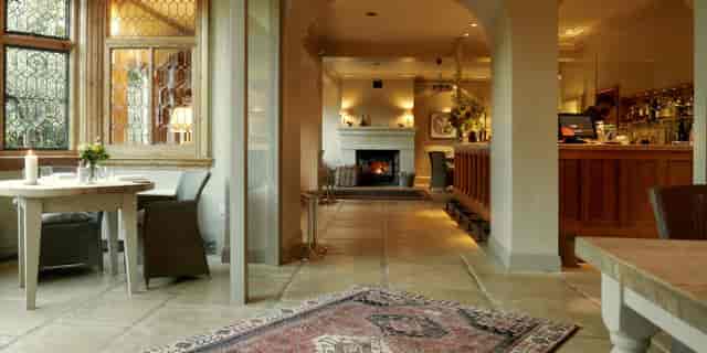 Welcoming Downstairs Dining Room with fireplace for intimate gatherings or networking events.