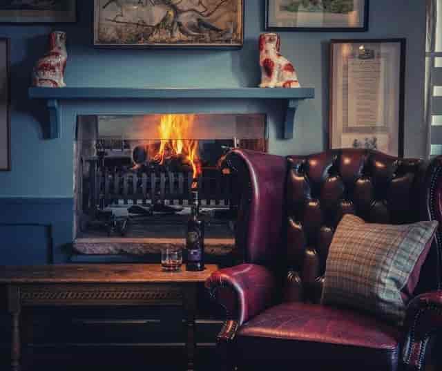 Cozy lounge at Loch Lomond Arms, featuring leather chairs for intimate meetings and gatherings.