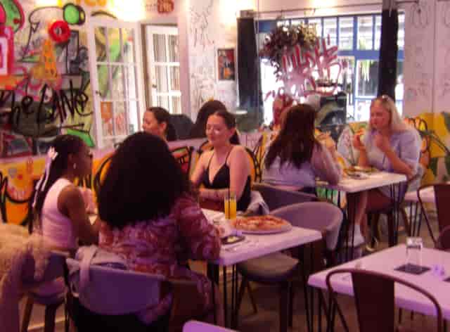 Vibrant venue with graffiti walls for casual gatherings and creative events.