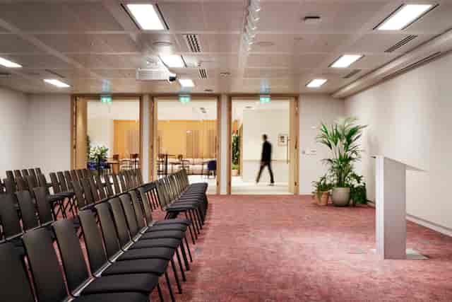 Versatile meeting space at Bon Hub, featuring rows of chairs for seminars and presentations.