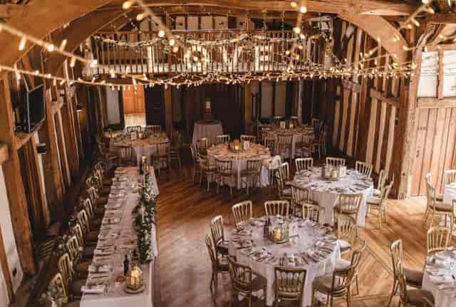 Exclusive hire event space in The Tudor Barn with rustic wooden beams, ideal for weddings.