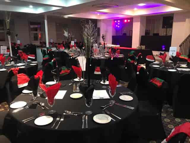 Banquet setup in Merlot Suite with holiday decor for corporate events or celebrations.