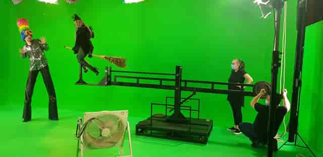 Green screen studio setup for hybrid events with staging equipment and collaborative team.