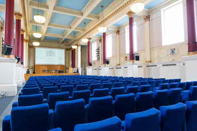 Spacious conference room with blue chairs for meetings and presentations in BMA House.