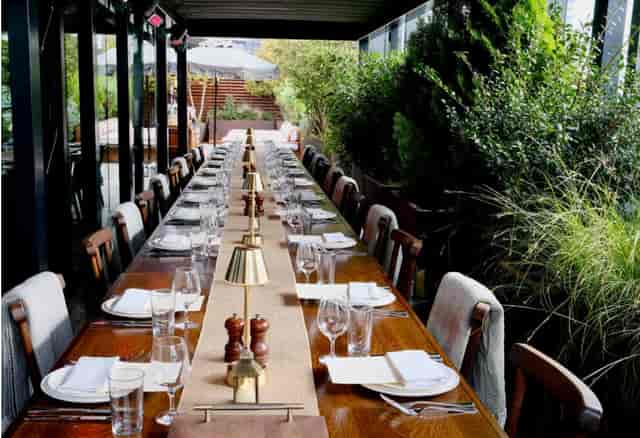 Elegant long table setup in Studio 8 for networking events and intimate receptions.