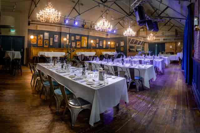 The Boston Room event space with industrial rafters, ideal for formal banquets and dinners.