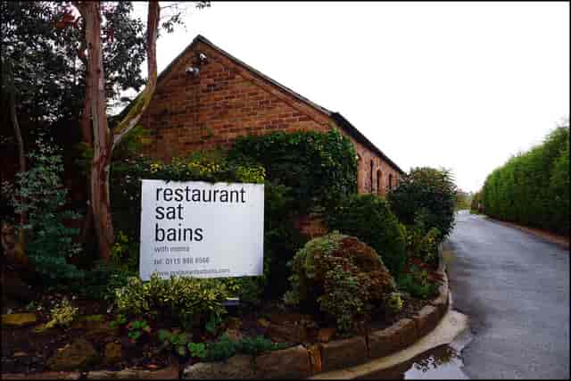"Upscale Courtyard Garden entrance at Restaurant Sat Bains for elegant events and gatherings."