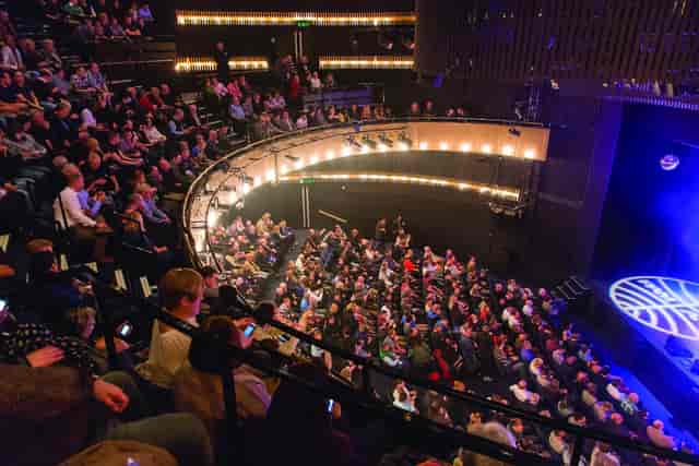 "Nottingham Playhouse Main Stage with engaged audience at a theater performance event."