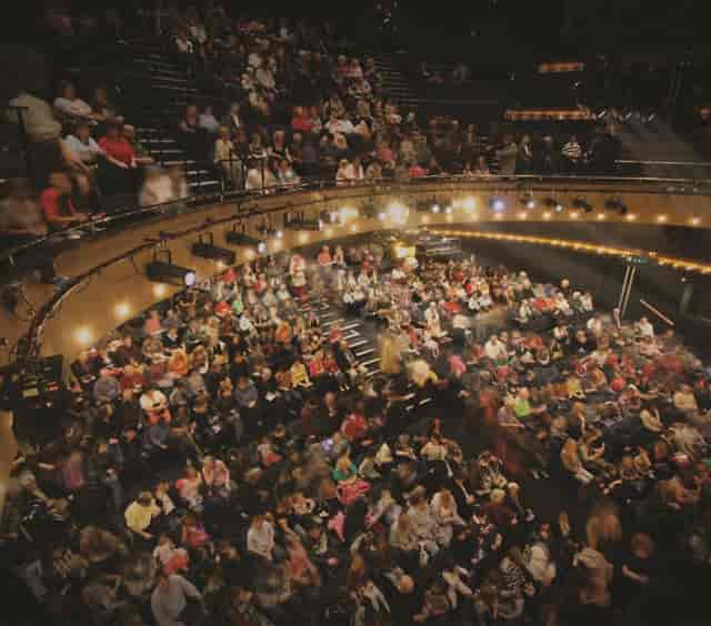 Main Stage at Nottingham Playhouse with engaged audience in vibrant theater setting.
