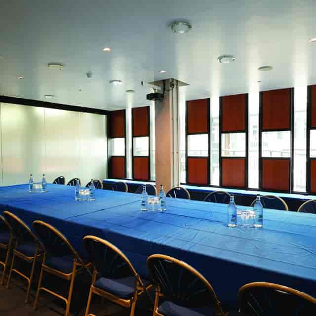 Ustinov Room with blue linens, ideal for corporate meetings and workshops.
