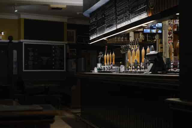The Old Cold Store bar with polished taps, perfect for networking events and gatherings.