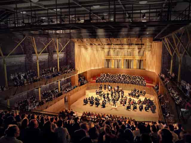 "Royal Concert Hall auditorium with large orchestra and engaged audience at concert event"