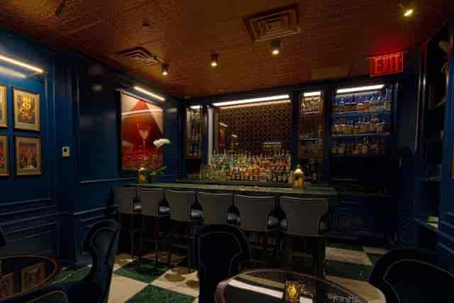 The Crown Post Room bar at The Bell Inn, featuring rich blue walls for stylish gatherings.