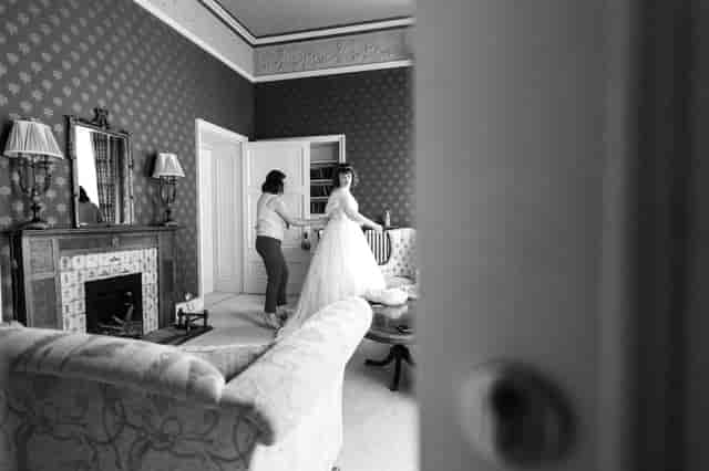 Bride getting ready in elegant Lady's Chamber, Wollaton Hall for sophisticated wedding.