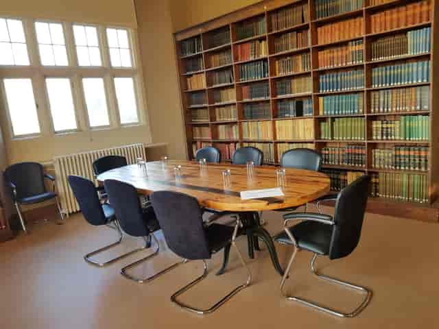 Lord Middleton Suite at Wollaton Hall: elegant meeting room with wooden table for professional events.