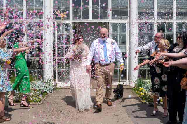 Joyful outdoor wedding reception at Lord Middleton Suite, featuring confetti and floral decor.