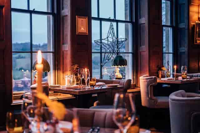 Oak Room at Burleigh Court with warm lighting, ideal for private dining and corporate events.