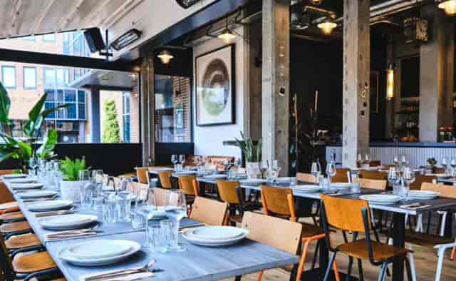 Event space in London with communal dining table, ideal for networking and gatherings.