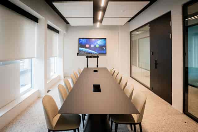 Modern boardroom with AV tech for hybrid meetings and corporate events.